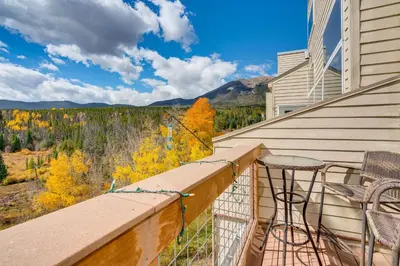 a balcony with a table and chairs and a view at 3 Mi to Dtwn Pet-Friendly Condo in Silverthone in Silverthorne