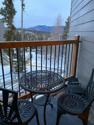 a patio with a table and chairs on a balcony at Summit County Wildernest Condo in Silverthorne