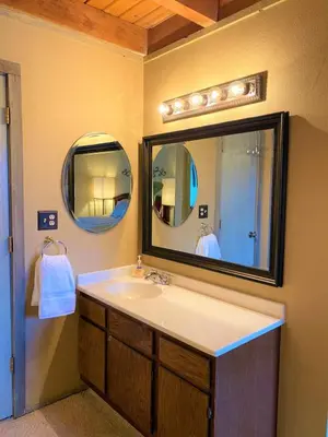 a bathroom with a sink and a large mirror at Summit County Wildernest Condo in Silverthorne