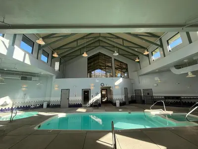a large indoor swimming pool in a building at Summit County Wildernest Condo in Silverthorne