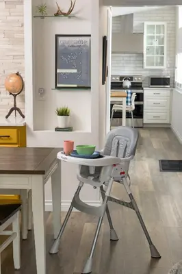 a kitchen with a small table and a chair at Cozy Family Retreat with Yard - Walk to Olde Town in Arvada