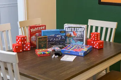 a wooden table with snacks and games on it at Cozy Family Retreat with Yard - Walk to Olde Town in Arvada