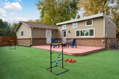 a backyard with a play equipment in the grass at Cozy Family Retreat with Yard - Walk to Olde Town in Arvada