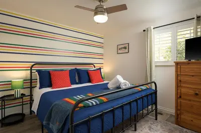 a bedroom with a bed with colorful striped walls at Cozy Family Retreat with Yard - Walk to Olde Town in Arvada