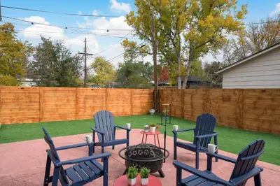 a patio with three blue chairs and a table at Cozy Family Retreat with Yard - Walk to Olde Town in Arvada