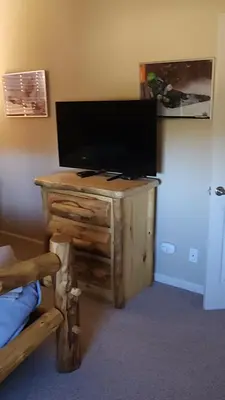 a flat screen tv sitting on top of a wooden table at Meadow Ridge Mountain Views 8 minutes from Basecamp in Winter Park