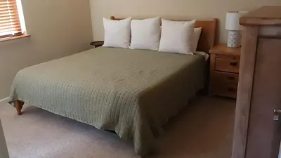 a bedroom with a large bed with white pillows at Meadow Ridge Mountain Views 8 minutes from Basecamp in Winter Park