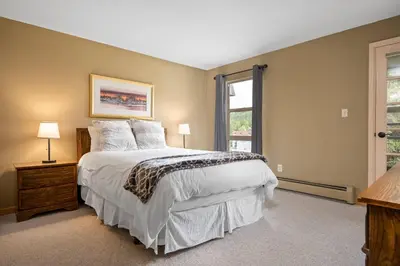 a bedroom with a large bed and a window at Ski Town Hideaway | Fireplace + Walk to Downtown in Winter Park