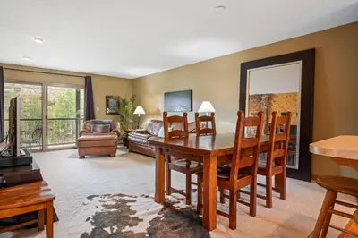 a living room with a table and chairs and a couch at Ski Town Hideaway | Fireplace + Walk to Downtown in Winter Park