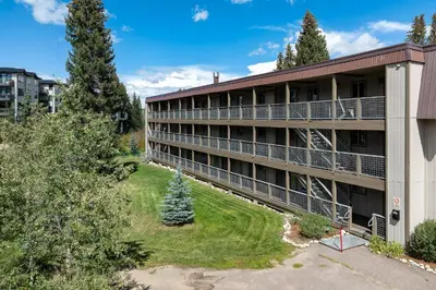 an aerial view of an apartment building with trees at Ski Town Hideaway | Fireplace + Walk to Downtown in Winter Park
