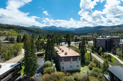 an aerial view of a city with mountains in the background at Ski Town Hideaway | Fireplace + Walk to Downtown in Winter Park