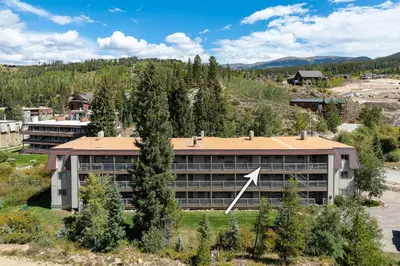 an overhead view of a building with a tree at Ski Town Hideaway | Fireplace + Walk to Downtown in Winter Park