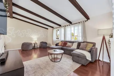 a living room with a couch and a table at 6BD Near DT - BBQ Grill, Games & Football Fun in Arvada