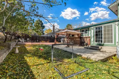 a backyard with a gazebo and a house at 6BD Near DT - BBQ Grill, Games & Football Fun in Arvada