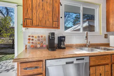 a kitchen with a sink and a dishwasher at 6BD Near DT - BBQ Grill, Games & Football Fun in Arvada