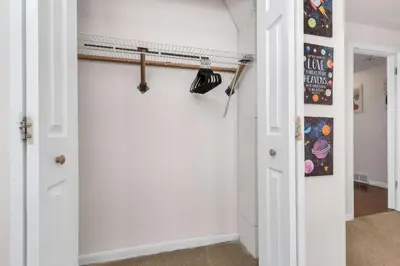 a room with a white wall with a shelf at 6BD Near DT - BBQ Grill, Games & Football Fun in Arvada