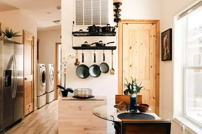 a kitchen with a table and a refrigerator at Ralston Creek Cottage - Serene Park Views in Arvada