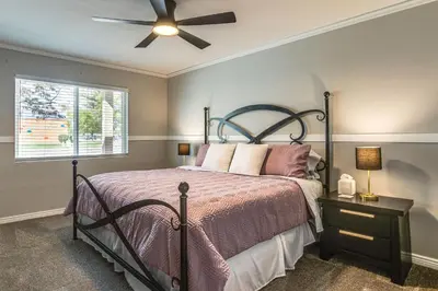 a bedroom with a bed and a ceiling fan at Suburban Home 9 Mi to Dtwn Denver Outdoor Oasis! in Aurora
