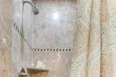 a bathroom with a shower with a shower curtain at Suburban Home 9 Mi to Dtwn Denver Outdoor Oasis! in Aurora