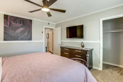 a bedroom with a bed and a desk and a ceiling fan at Suburban Home 9 Mi to Dtwn Denver Outdoor Oasis! in Aurora