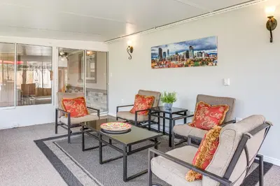 a living room with couches and a table at Suburban Home 9 Mi to Dtwn Denver Outdoor Oasis! in Aurora