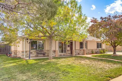 a home with a tree in the yard at Suburban Home 9 Mi to Dtwn Denver Outdoor Oasis! in Aurora