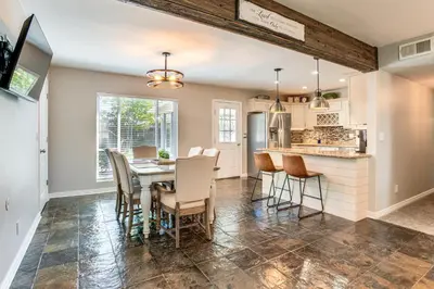 a kitchen and dining room with a table and chairs at Suburban Home 9 Mi to Dtwn Denver Outdoor Oasis! in Aurora