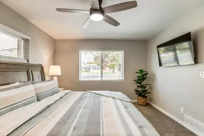 a bedroom with a bed and a ceiling fan at Suburban Home 9 Mi to Dtwn Denver Outdoor Oasis! in Aurora