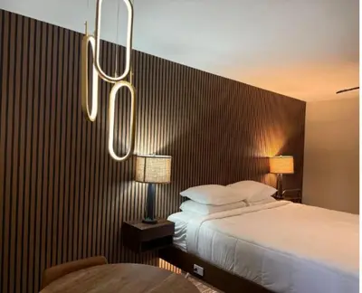 a hotel room with a bed and two lamps at Lone Eagle Lodge in Grand Lake