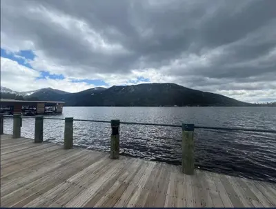 a dock on a body of water with mountains at Lone Eagle Lodge in Grand Lake