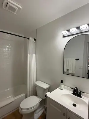 a bathroom with a toilet and a sink and a mirror at Lone Eagle Lodge in Grand Lake