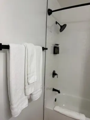 a bathroom with white towels and a shower at Lone Eagle Lodge in Grand Lake