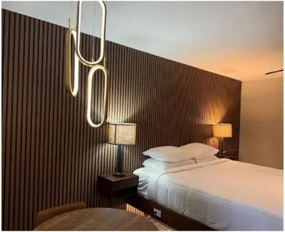 a bedroom with a large bed and two lamps at Lone Eagle Lodge in Grand Lake