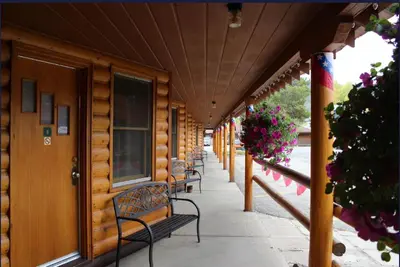a row of benches on a building with flowers at Lone Eagle Lodge in Grand Lake