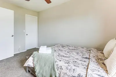 a bedroom with a bed and a table at Fenced-In Yard with Deck Pet-Friendly Lochbuie Home
