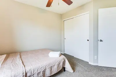 a bedroom with a bed and a ceiling fan at Fenced-In Yard with Deck Pet-Friendly Lochbuie Home