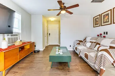 a living room with a couch and a ceiling fan at Fenced-In Yard with Deck Pet-Friendly Lochbuie Home