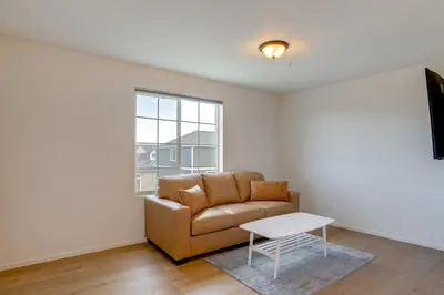 a living room with a couch and a table at Newly Built Home with Garage, 10 Mi to Anschutz! in Aurora