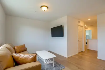 a living room with a couch and a table at Newly Built Home with Garage, 10 Mi to Anschutz! in Aurora