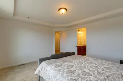 a white bedroom with a bed in a room at Newly Built Home with Garage, 10 Mi to Anschutz! in Aurora