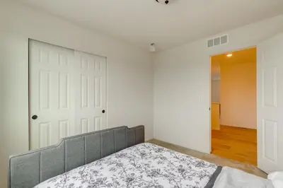 a bedroom with a bed in front of a door at Newly Built Home with Garage, 10 Mi to Anschutz! in Aurora