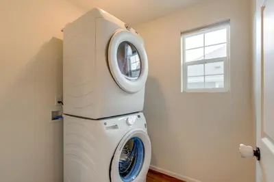 a washer and dryer in a room with a window at Newly Built Home with Garage, 10 Mi to Anschutz! in Aurora