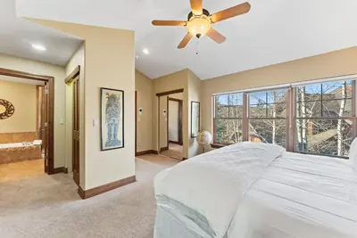 a bedroom with a bed and a ceiling fan at Breckenridge Stay Hot Tub Walk to Trails in Breckenridge