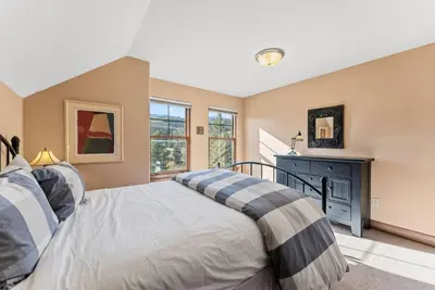 a bedroom with a bed and a window at Breckenridge Stay Hot Tub Walk to Trails in Breckenridge