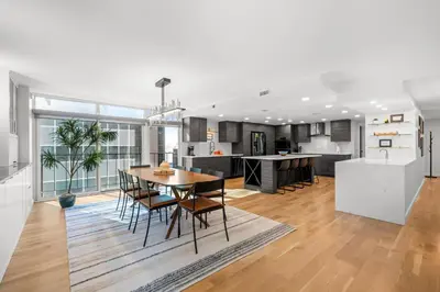 a kitchen and living room with a table and chairs at 1777 Larimer 910 in Denver