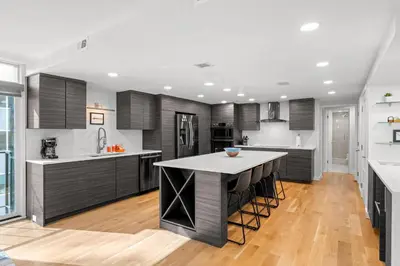 a kitchen with black cabinets and a white counter top at 1777 Larimer 910 in Denver