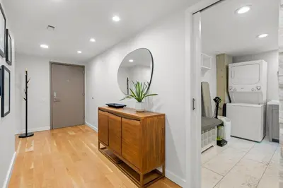 a living room with a dresser and a mirror at 1777 Larimer 910 in Denver