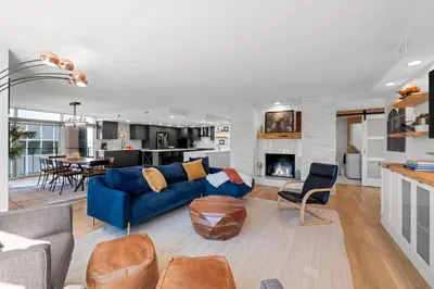 a living room with a blue couch and a kitchen at 1777 Larimer 910 in Denver
