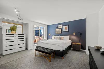 a bedroom with a king sized bed and a dresser at 1777 Larimer 910 in Denver