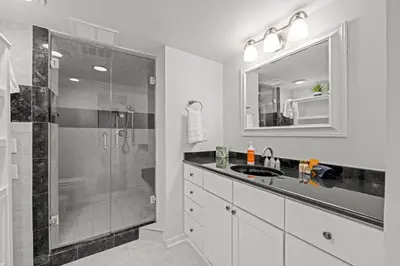 a bathroom with a shower and a sink and a mirror at 1777 Larimer 910 in Denver